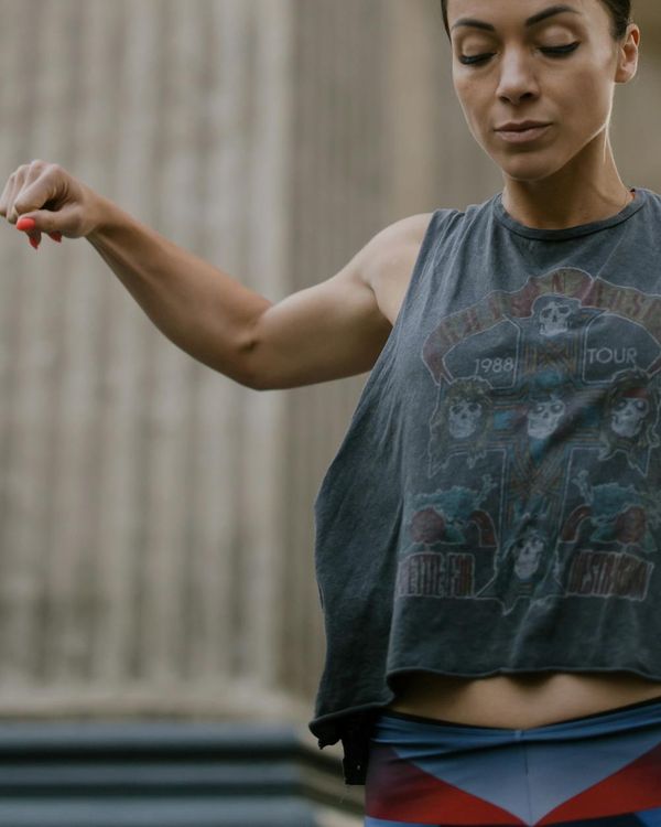 A woman performing a dynamic, energetic pose, radiating vitality.